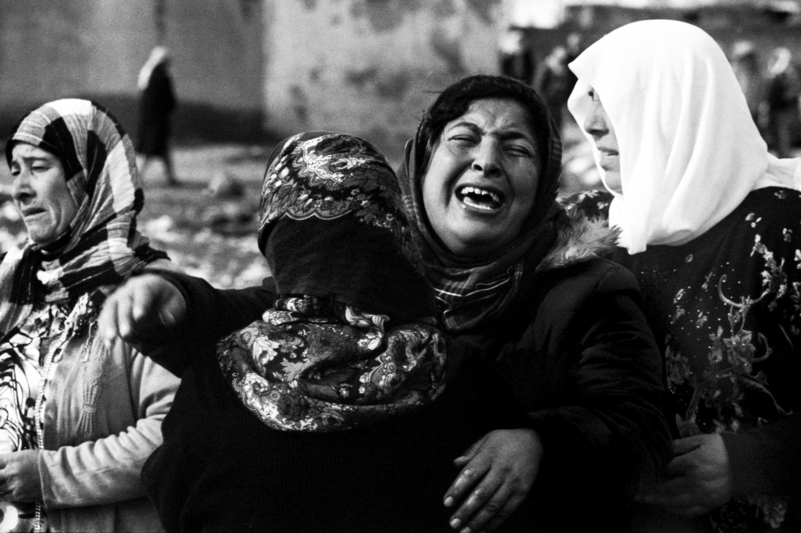 A woman collapses in despair wh...trikes on her homeland, Kobane.