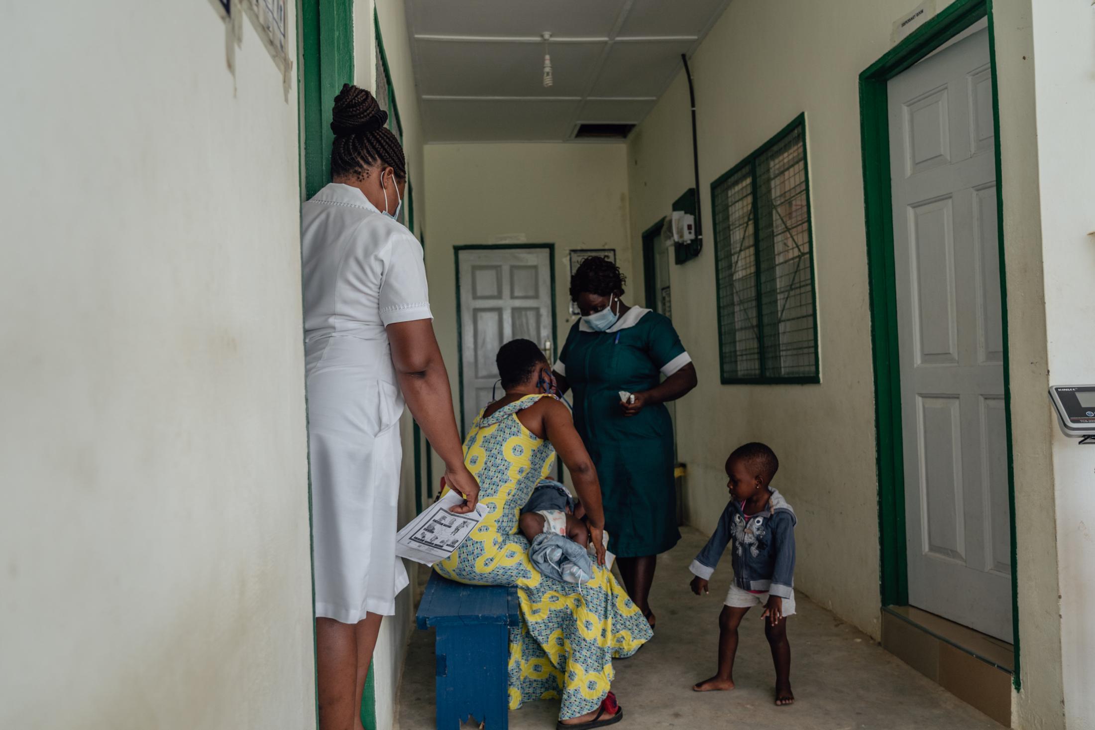 Covid-19 Response in Northern Ghana - Rita Abondobire (34) health staff at Awaradone CHPS gives...
