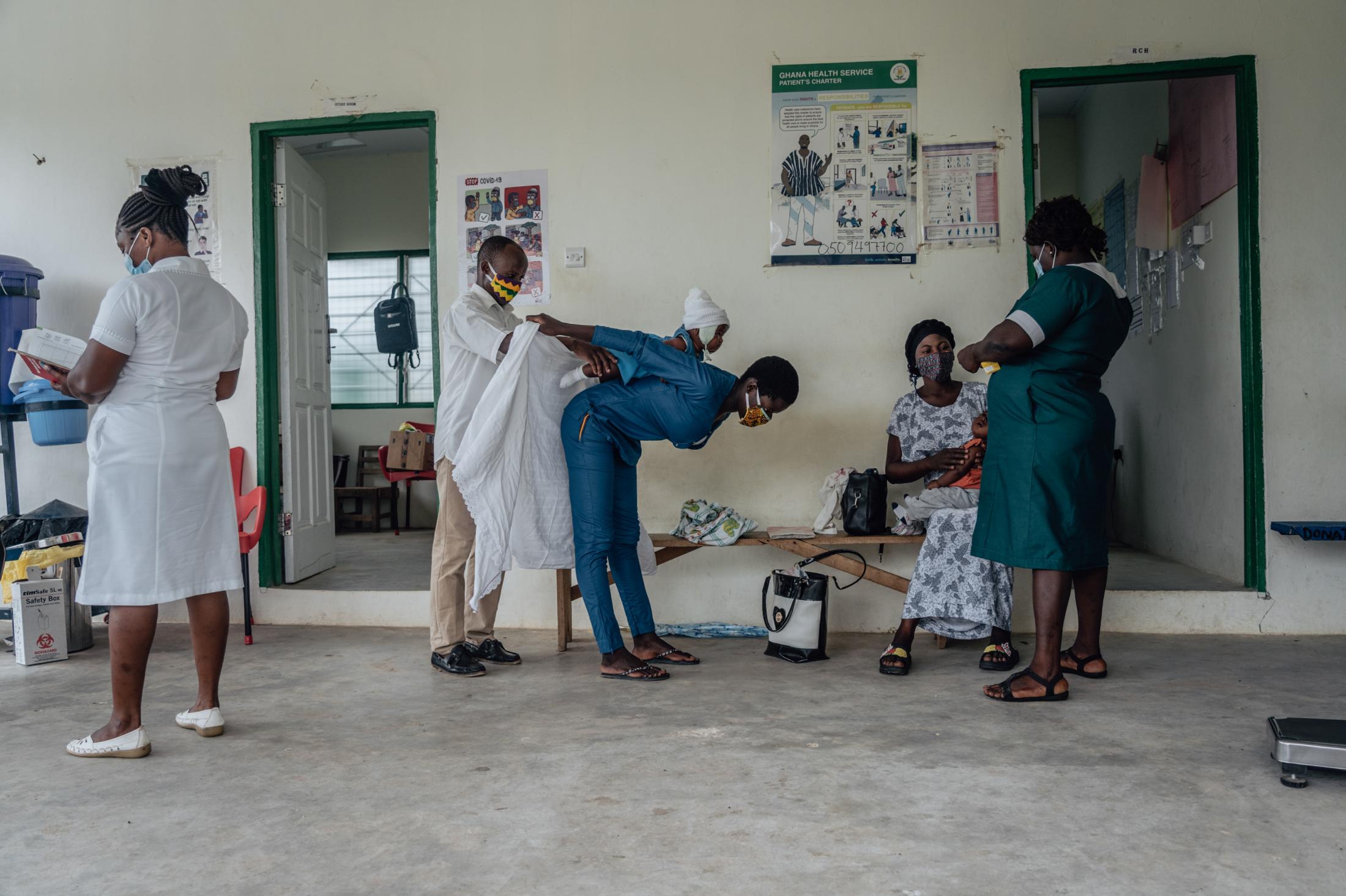 Covid-19 Response in Northern Ghana - Health Staff at Awaradone CHPS wear masks and practice...