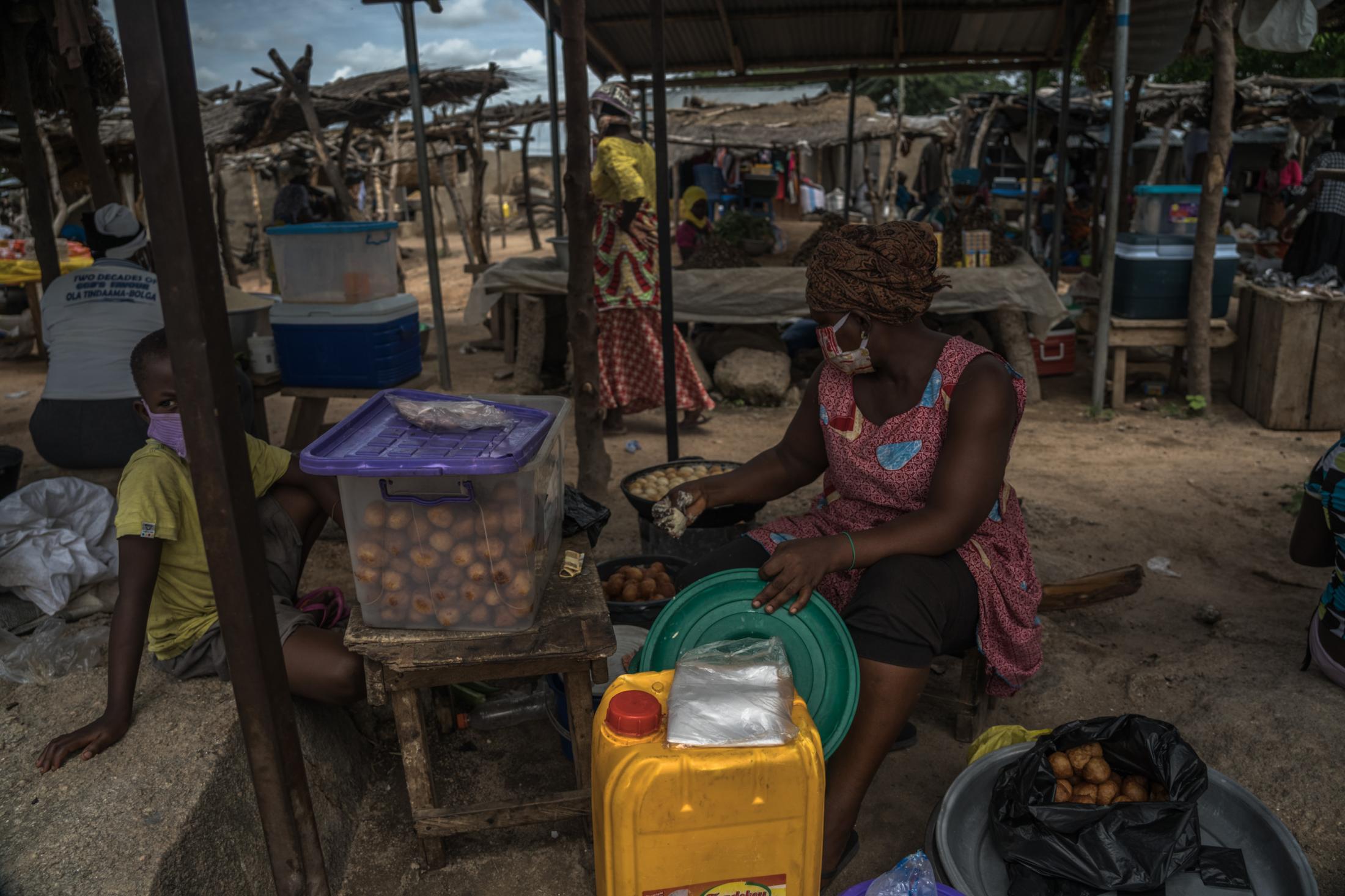 Covid-19 Response in Northern Ghana - Market woman Akosua Peter(39) wears a face mask at...
