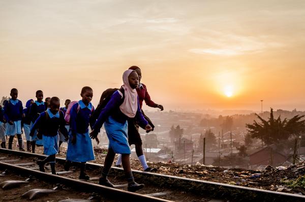 Brian Otieno | Kibera Stories - In the morning, children walk along the railway line in...
