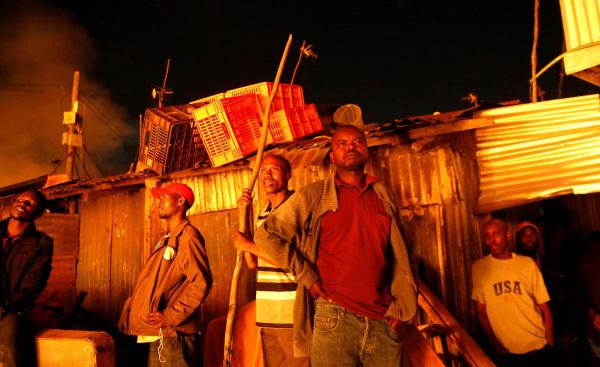 Thomas Mukoya | A Spectacular Failure - Residents watch as their houses burn in a fire that broke...