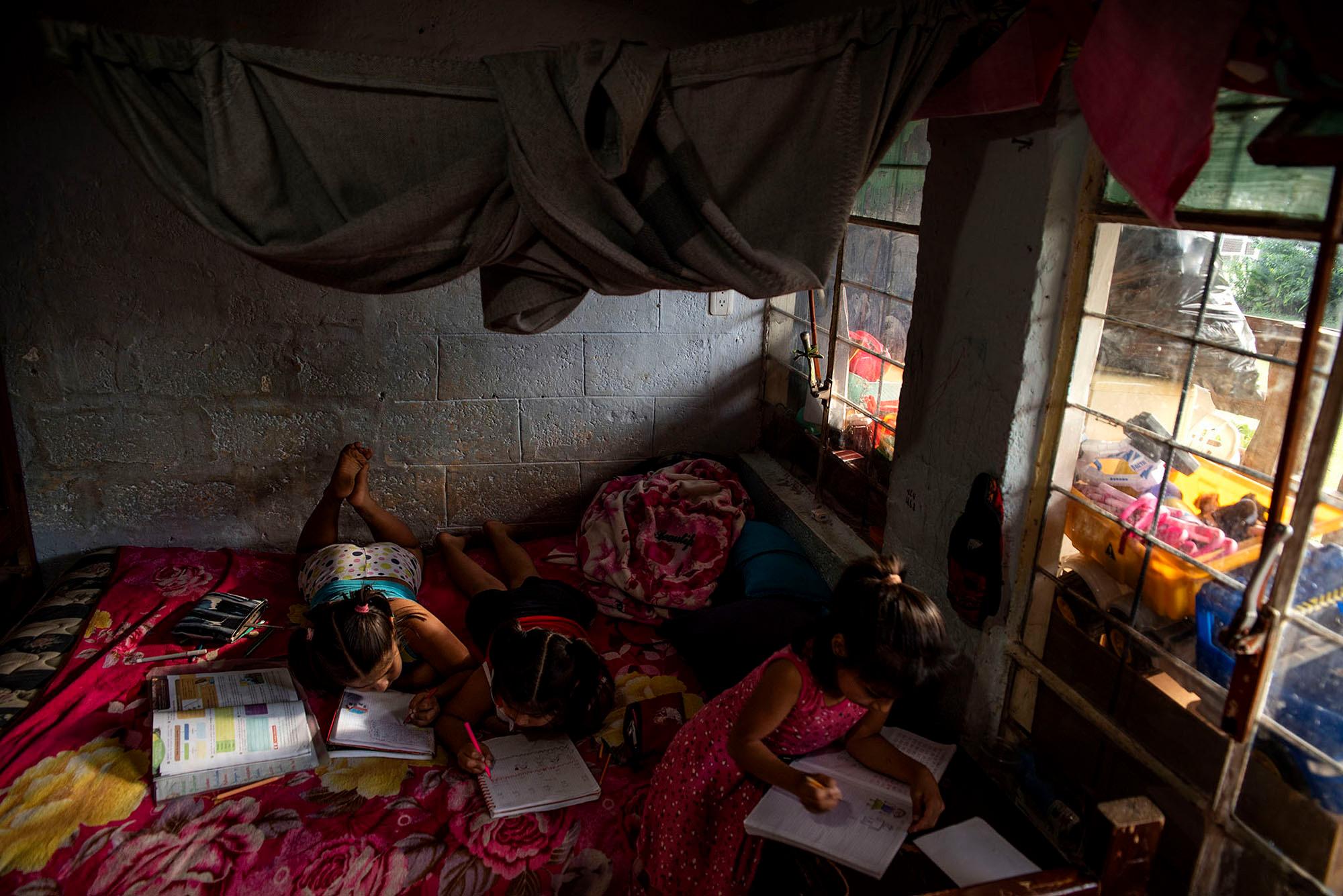 Roxana, Dom&eacute;nica, and Ramona do their homework at home. They don&acute;t have internet access at home so, they make weekly recharges of $ 5.00 to communicate with their teachers. Quito, June 24, 2020. Johis Alarc&oacute;n