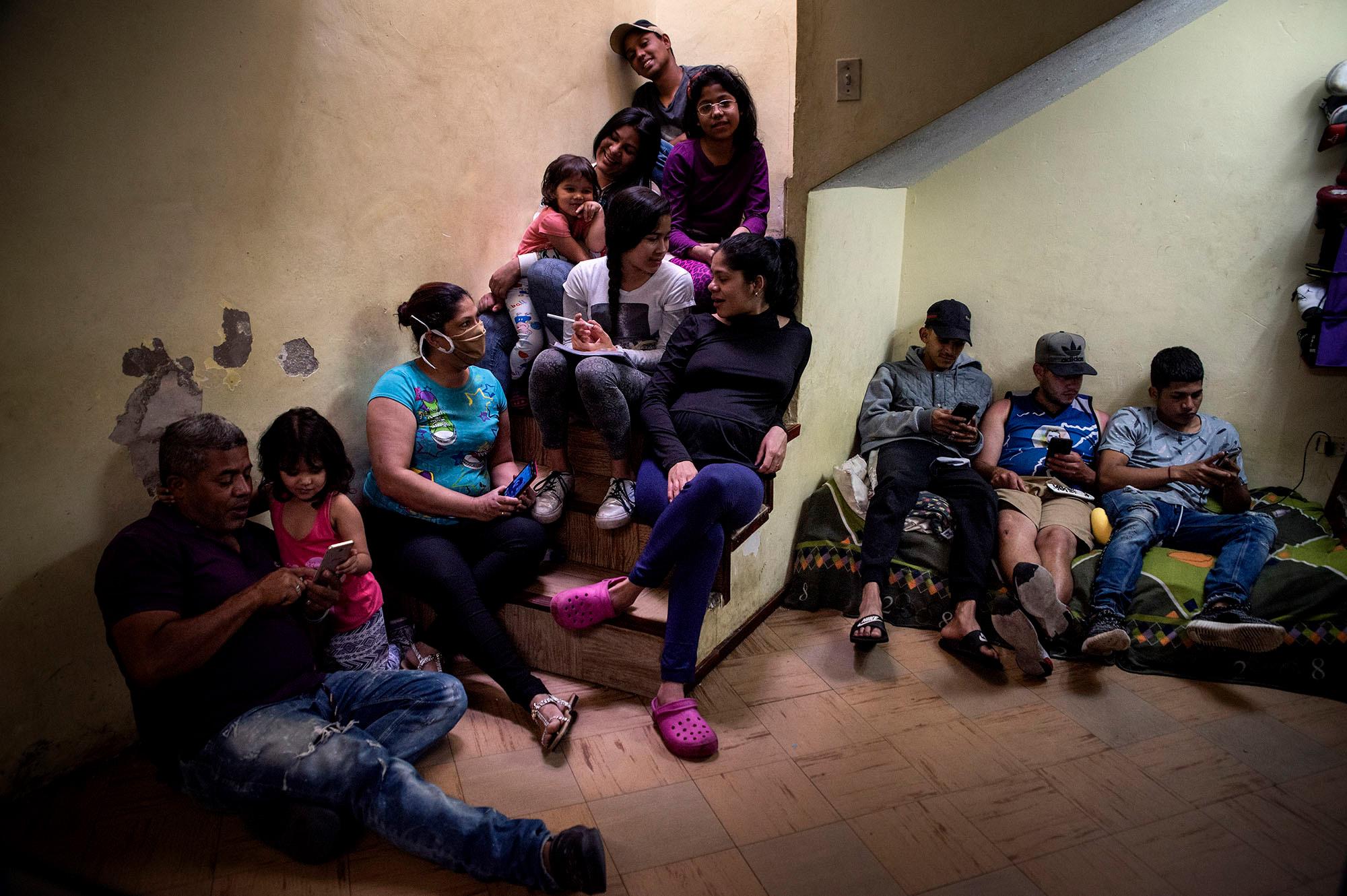 Portrait of the Venezuelan migrant family Blanco-Colmenares at their home during the quarantine. They don&acute;t have internet access and try to do the homework with weekend recharges on the cellphone. Sara (15) is a one of the three sisters, she has several vision problems that forbidden her continue with studies through zoom and WhatsApp.May 21, 2020. Quito-Ecuador. Johis Alarc&oacute;n 