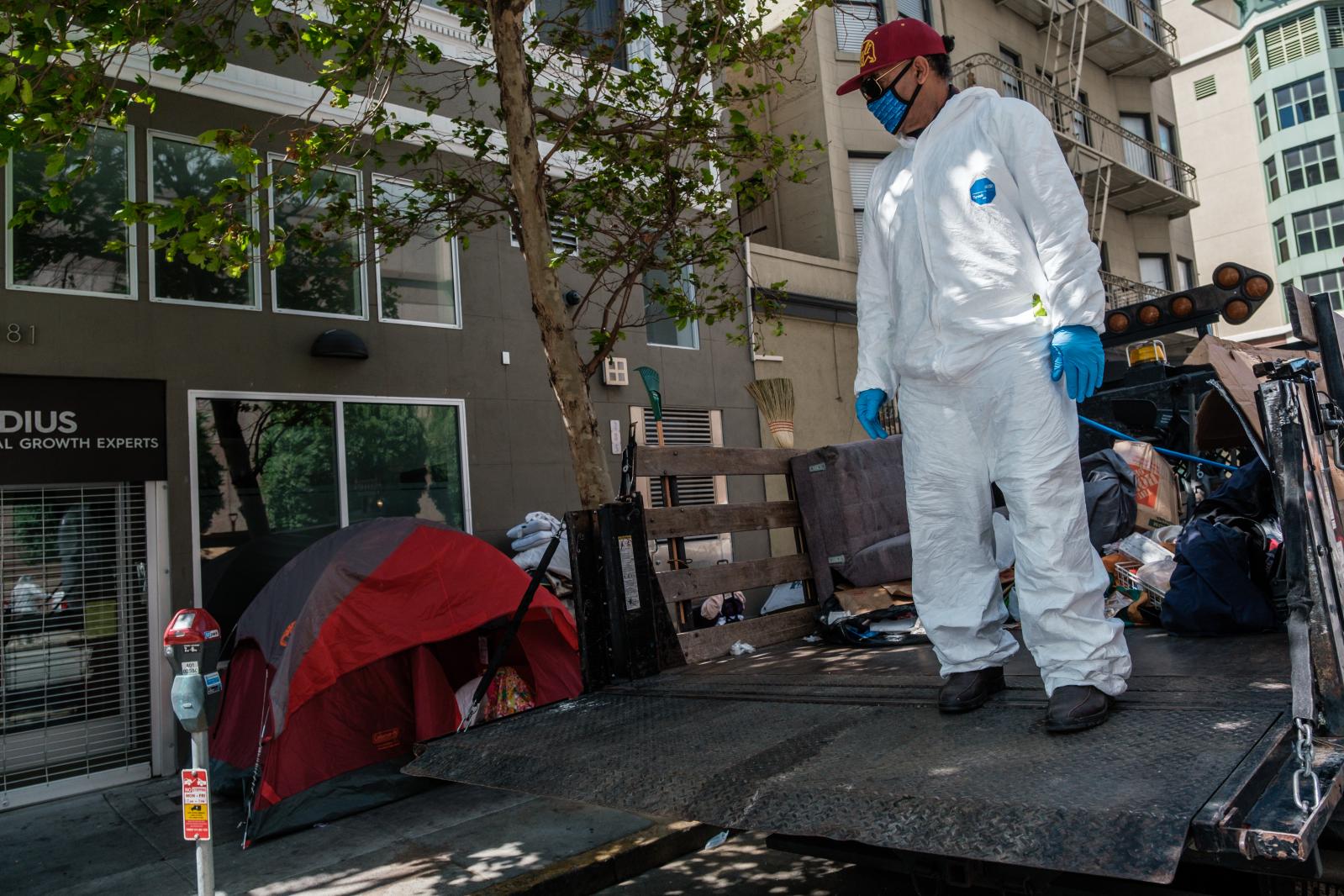 Image from San Francisco's Housing Crisis - City employee Abdul, helps people staying in a small tent...