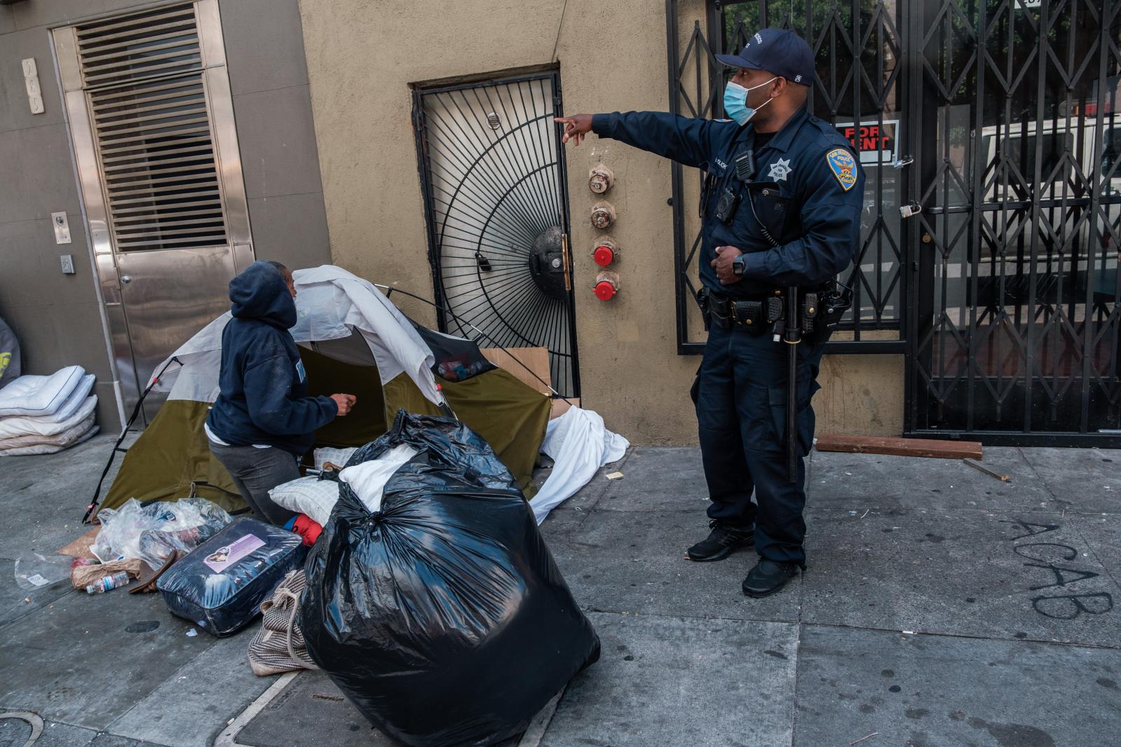 Image from San Francisco's Housing Crisis - Officer B. Holbrook speaks to a woman staying in a small...
