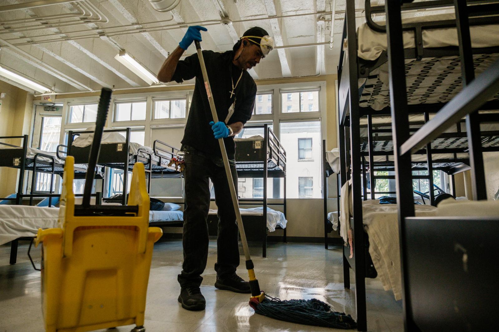 Image from San Francisco's Housing Crisis - Cliff Bonnet cleans the floors of the dormitory quarters...