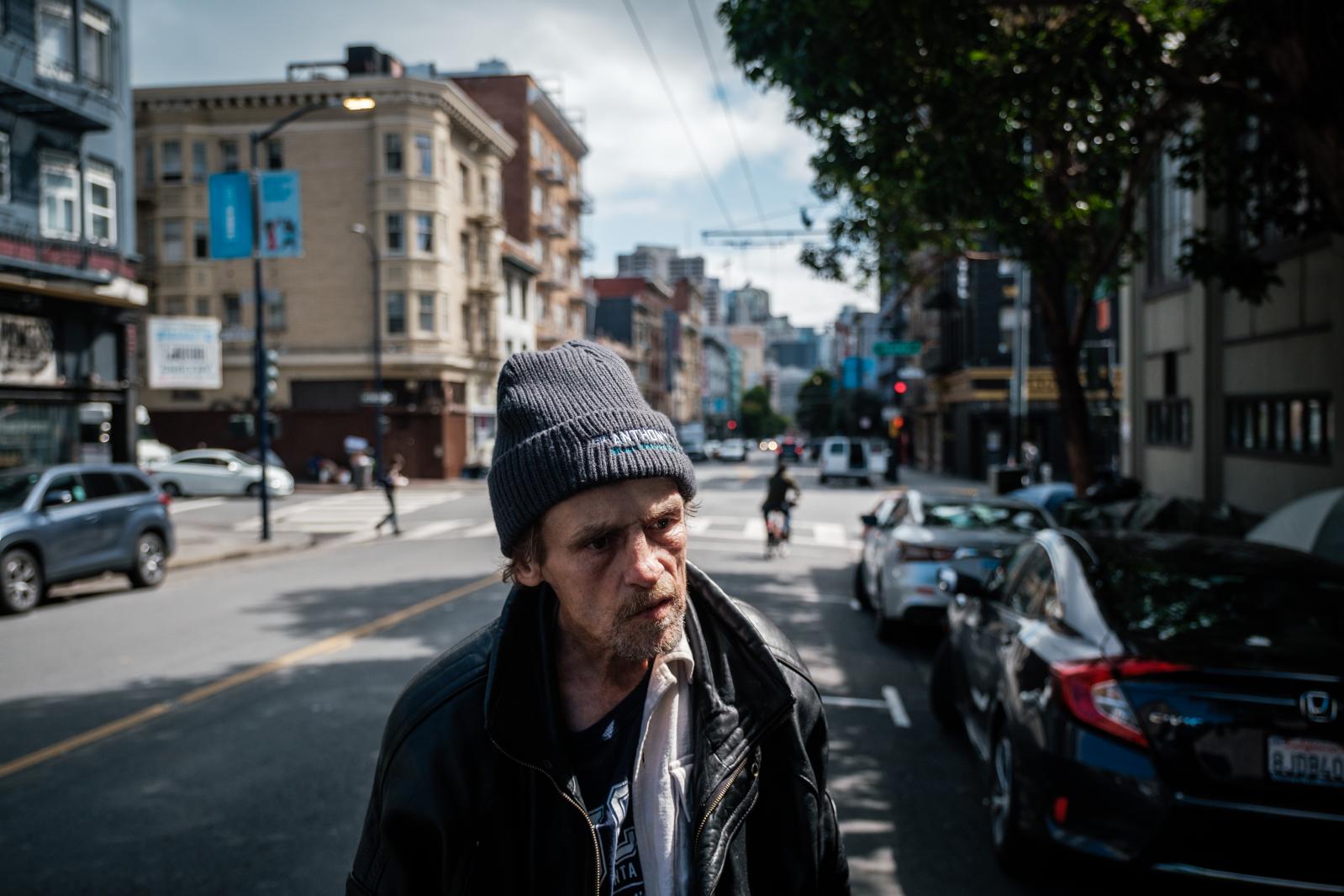 Image from San Francisco's Housing Crisis - Jeff Reaves, a homeless man, pauses on the street while...