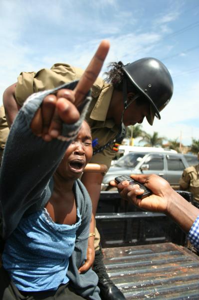 Image from 2013 NEWS CATEGORY WINNERS -  Abubaker Lubowa  2nd Place, News  Police arrest a woman...