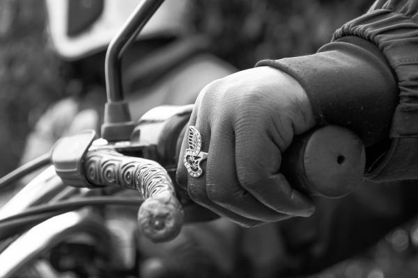 Image from Abdul Kinyenya Muyingo | A City Lady  - close up of Naomi's hands as she holds the bike and a...