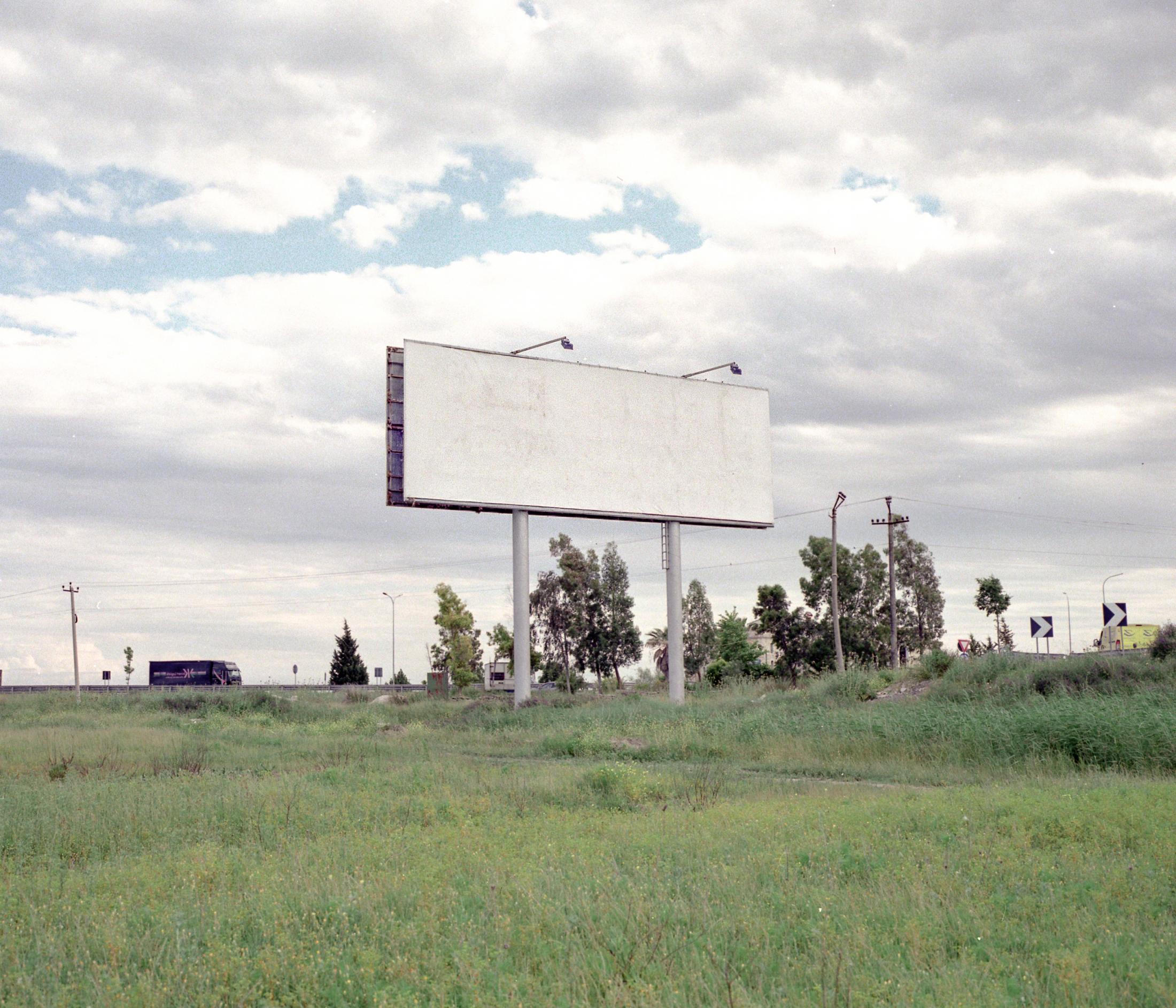 Area Albania - Orphan advertisement. A blank billboard sits by a highway...