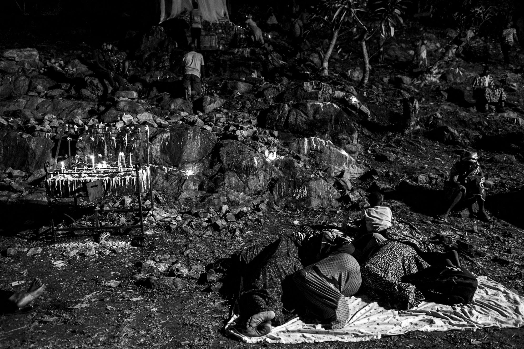 Pilgrims spend the night on the ground at the Our Lady of Lourdes grotto.