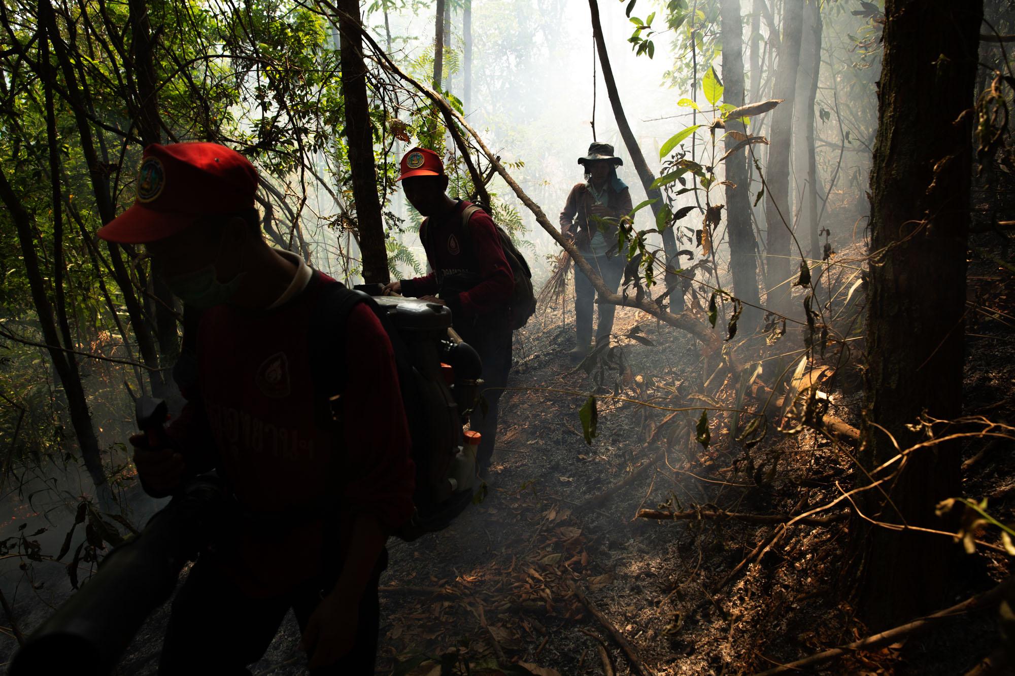 Fire fighters from Doi Mae Salong fire station make there way through a small fire, high up in the mountains, on their way to a much bigger blaze, April 2019.