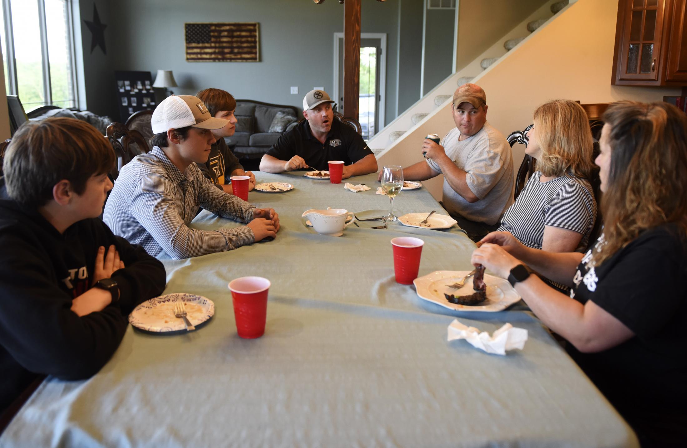 Family Farms Threatened by CAFOS - Fred Williams talks with his mother, center right, son,...