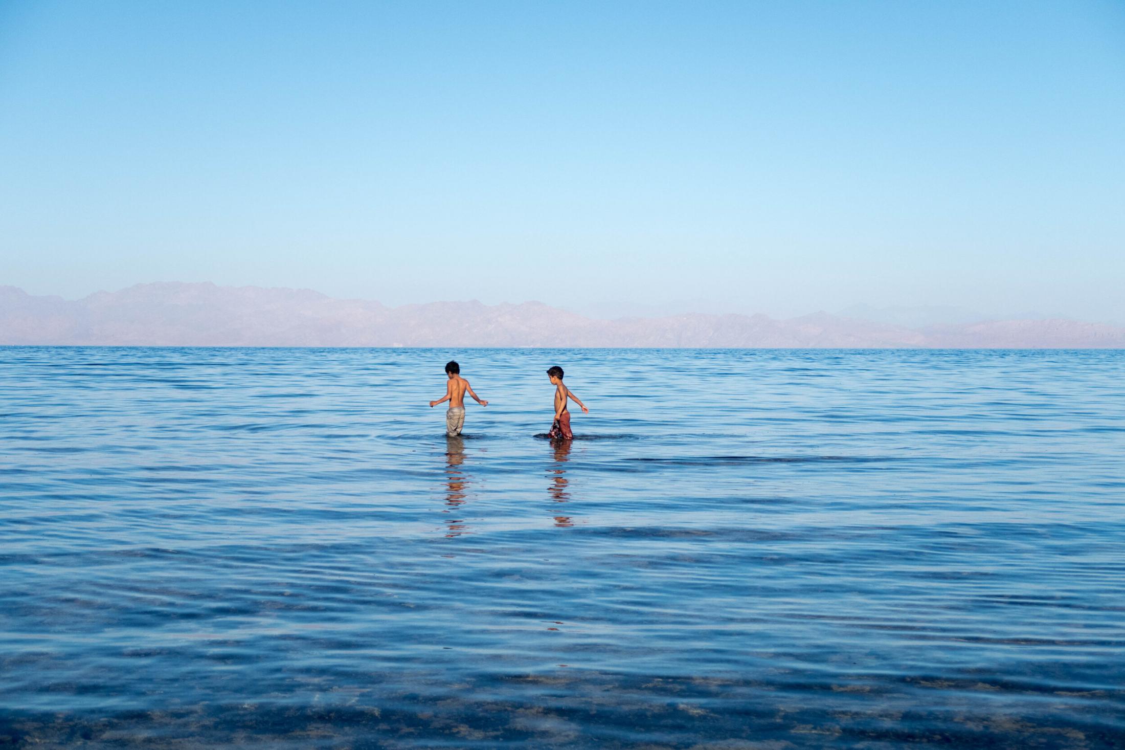 Travel - Dahab, South Sinai, Egypt  Two young boys fish off shore...