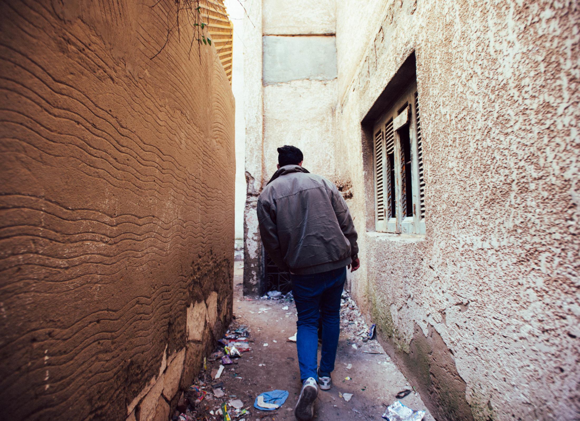 Travel -  Alexandria, Egypt  A young man walks through the...