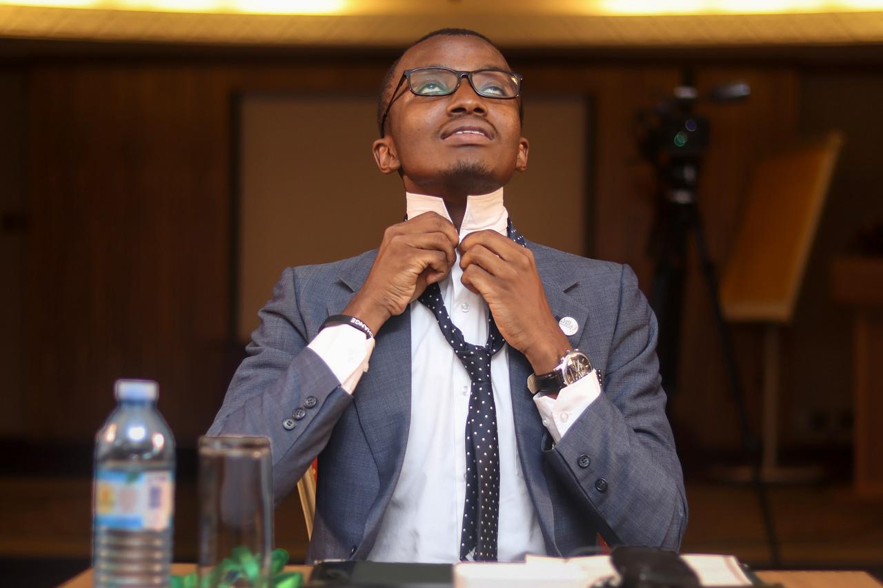 Stuart Tibaweswa | The Network  - Senior investigative journalist Raymond Mujuni puts on...