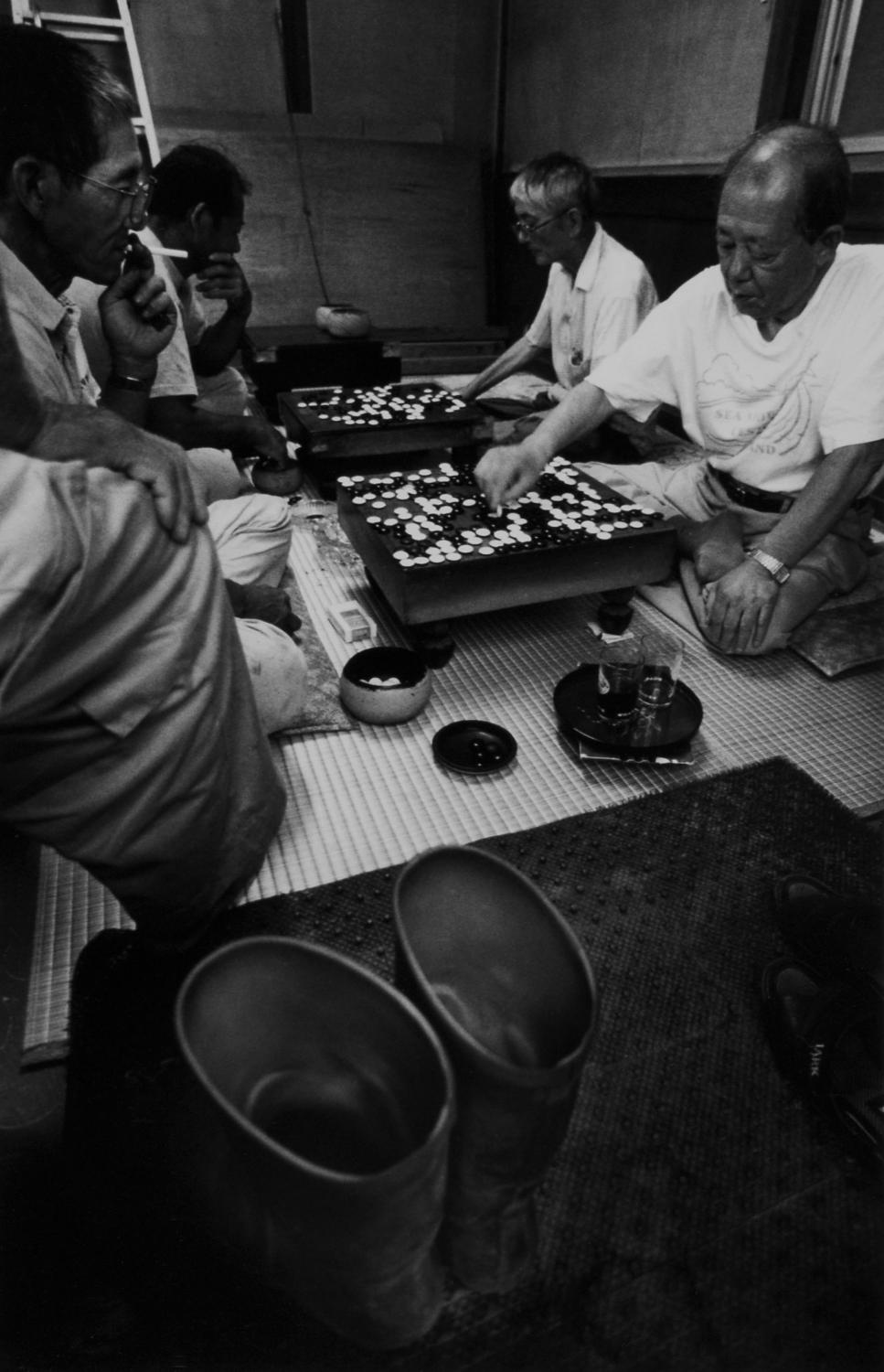 Hachijo:  Isle of Exile - The locals play Go game after work in a room next to...