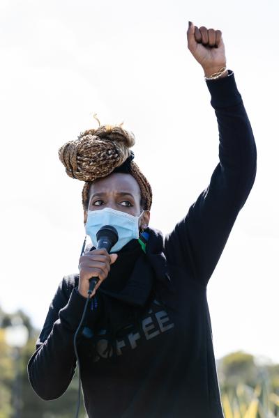 Image from Protests -  Selam Asmerom speaks to the audience during the Women in...