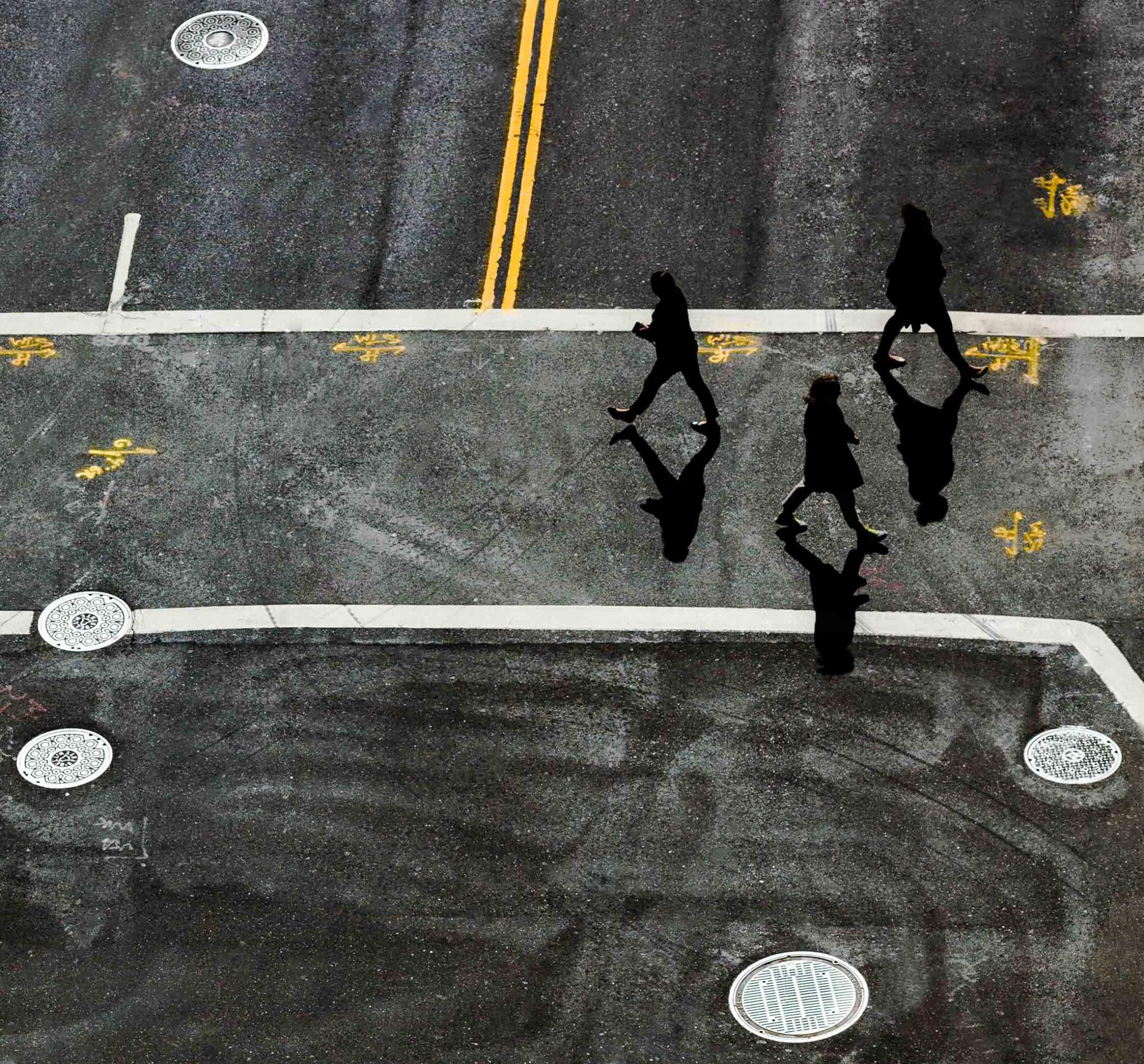 SINGLES -  Pedestrians cross a downtown street on Monday, February...