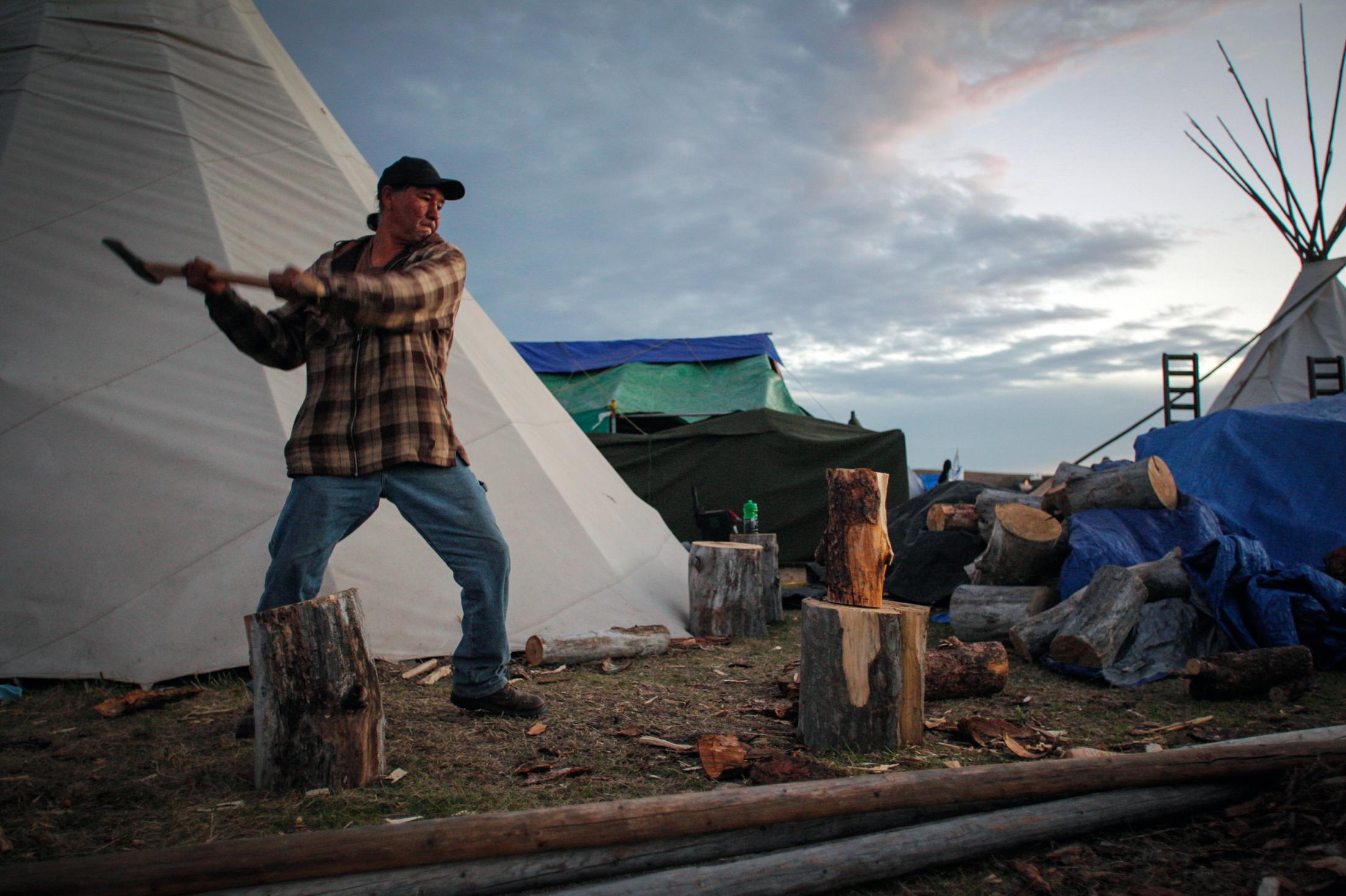 Decolonizing Water - Campers take turn chopping wood for the families living...