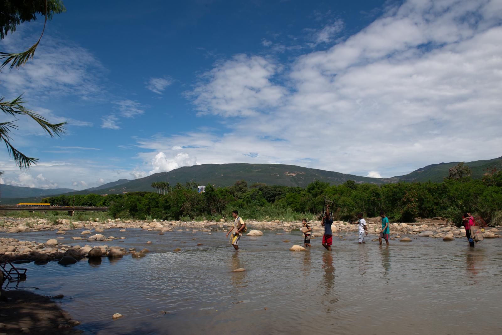 Garrucheras - People are seen crossing the River Tachira from Venezuela...