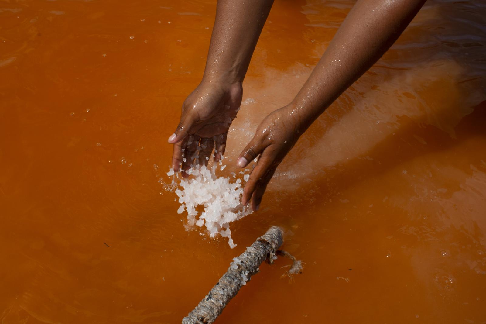 Bloomberg News - Salt Harvest  - A worker harvest salt in  Xtampú, Yucatan...