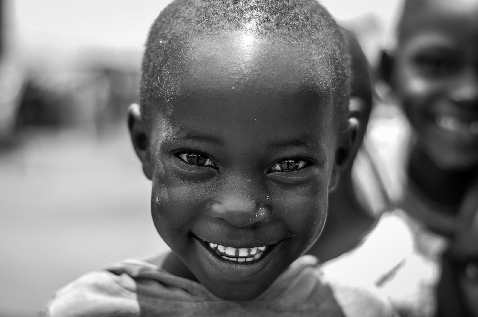 A CHILD IN KAYUNGA SMILES FOR THE CAMERA