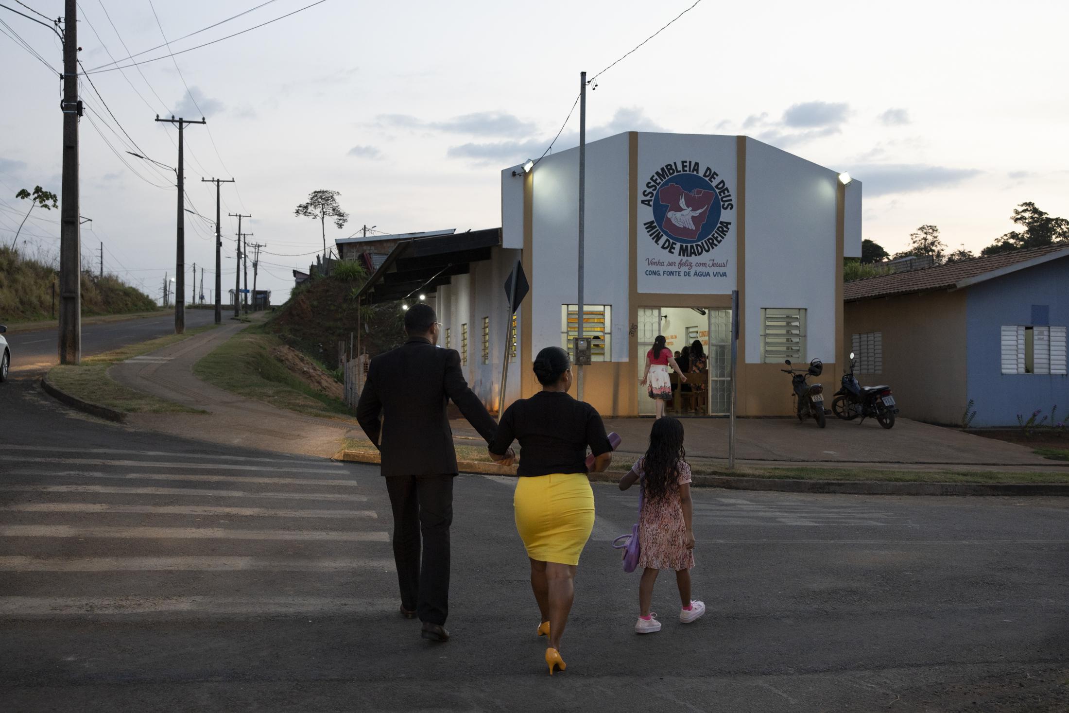 Altamira - A small evangelical family walks towards the church in...