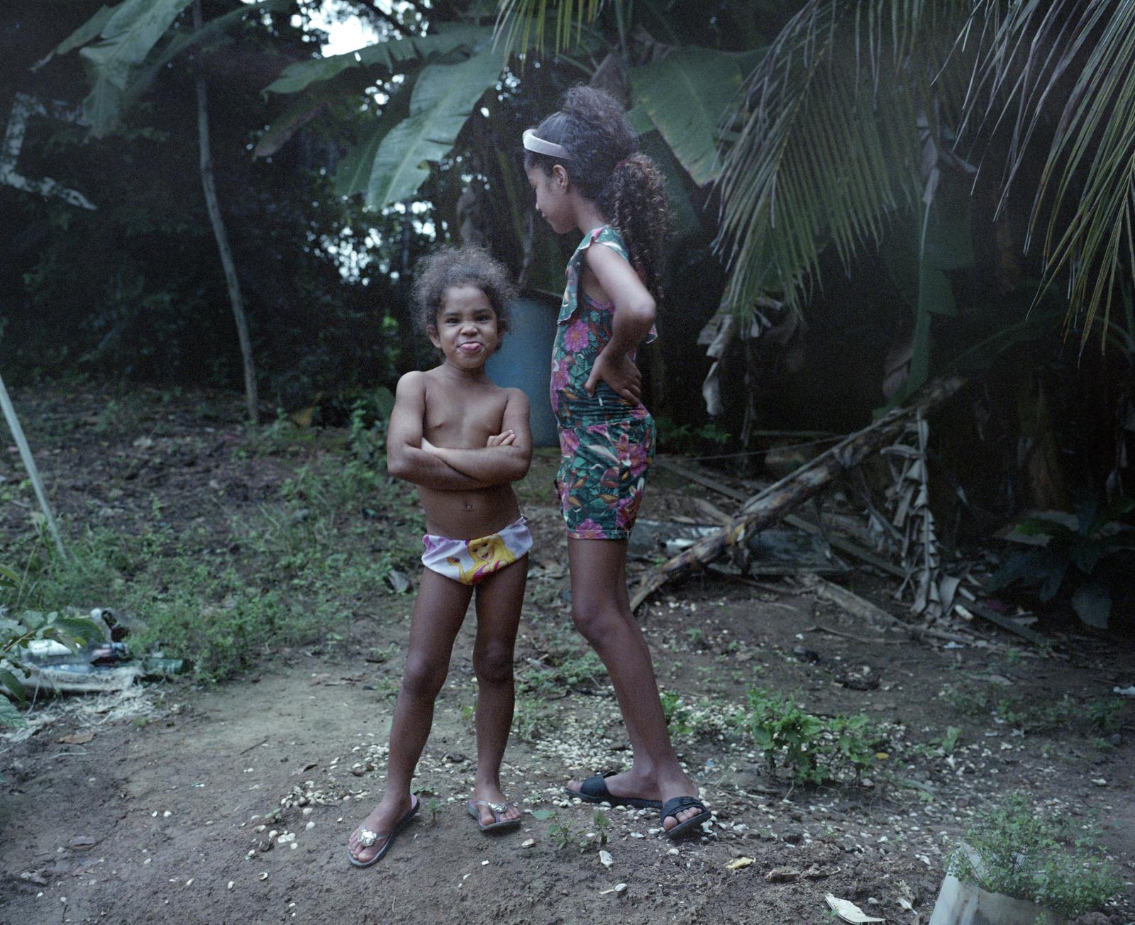  Candeias. Brazil. Ester and her cousin stand in front of their garden. Ester is the daughter of...