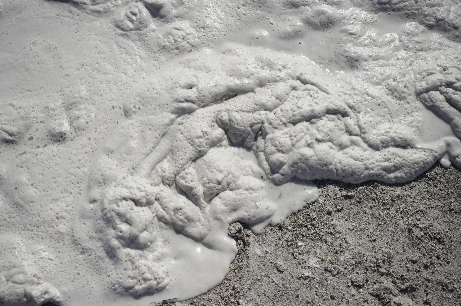 White foam in the beach in fron...iterraneum Sea. Rosignano Italy