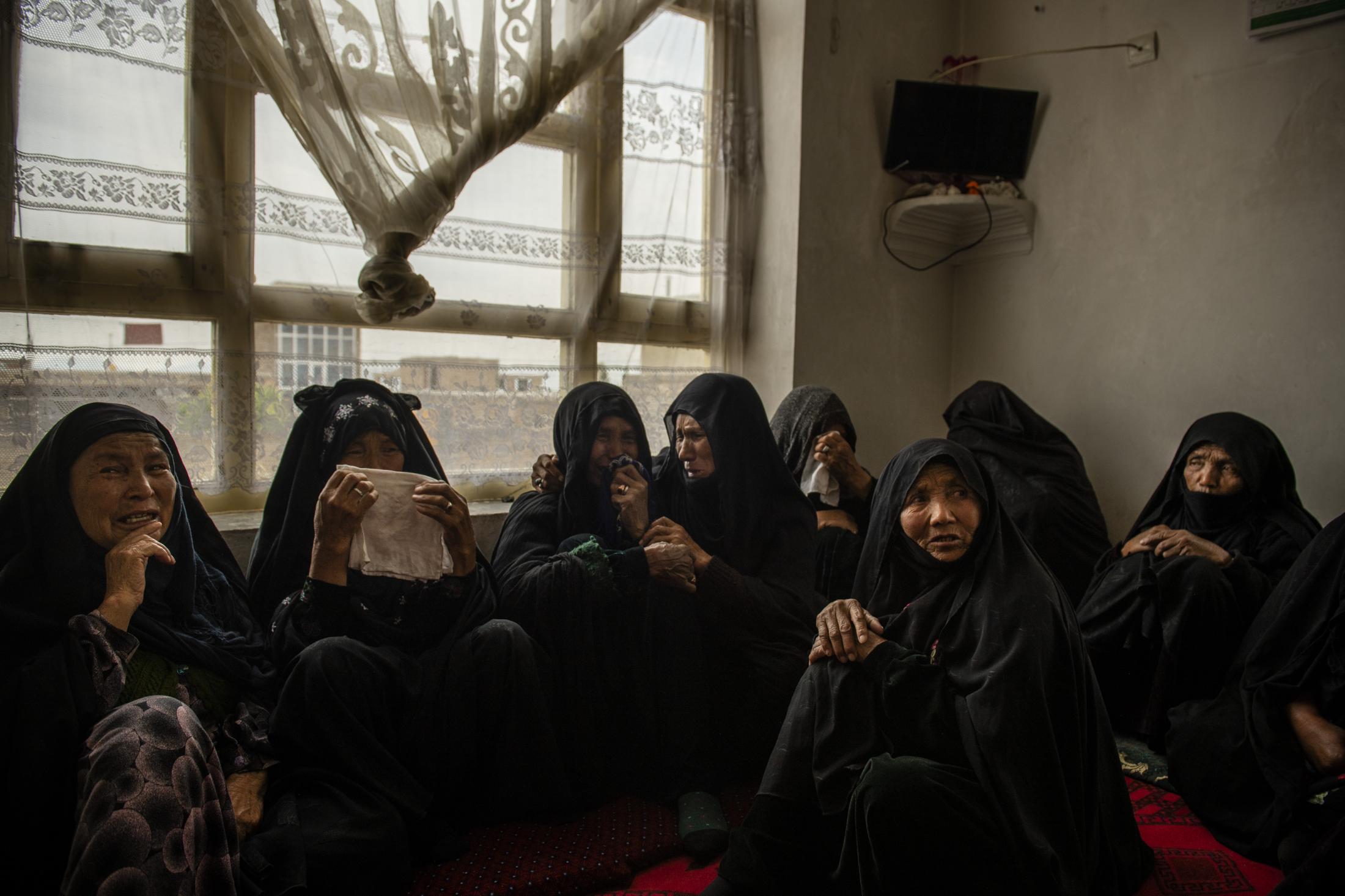 KABUL | KABUL | AFGHANISTAN | 5/13/20 | Hajar's mom is consoled and held by a family member. After Hajar and her unborn baby's burial, the women gathered inside one room to console her mother, mother-in-law and her sister and pay their respect to the family.