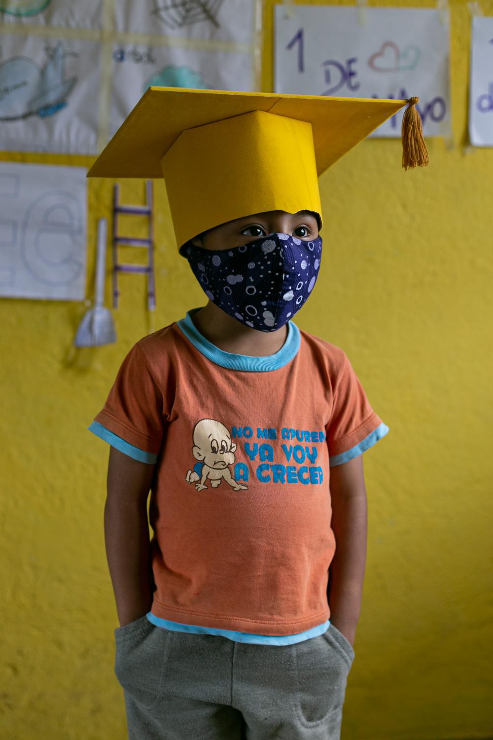 Education through Whatsapp  - Gael Pin (4) wears the cap and mask he will use at the...