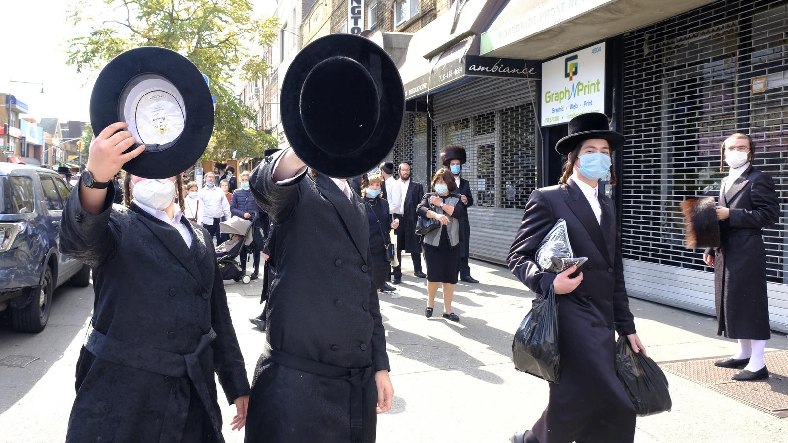 Brooklyn - October 7, 2020 - A group of Orthodox Jewish teenagers some wearing facial mask tries to block this photographer from taking pictures on 13th Avenue near 49th Street in the Borough Park section of Brooklyn Wednesday afternoon. NYPD 66th Precinct Officers showed at the scene but did not ticket or warned the mask less members of the crowd. New Yorkers who hold mass gatherings will be fined up to $15,000 per day, Mayor de Blasio announced Wednesday, the latest step aimed at cracking down on an alarming spike in COVID cases in parts of Brooklyn and Queens. (Luiz C. Ribeiro for New York Daily News)