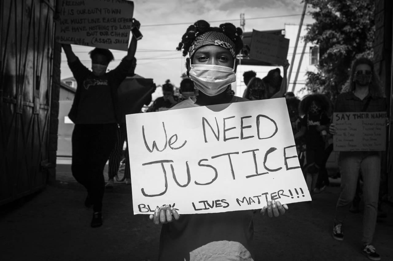 Image from 2020 NEWS CATEGORY WINNERS -  DeLovie Kwagala  Honourable Mention, News  A protestor...