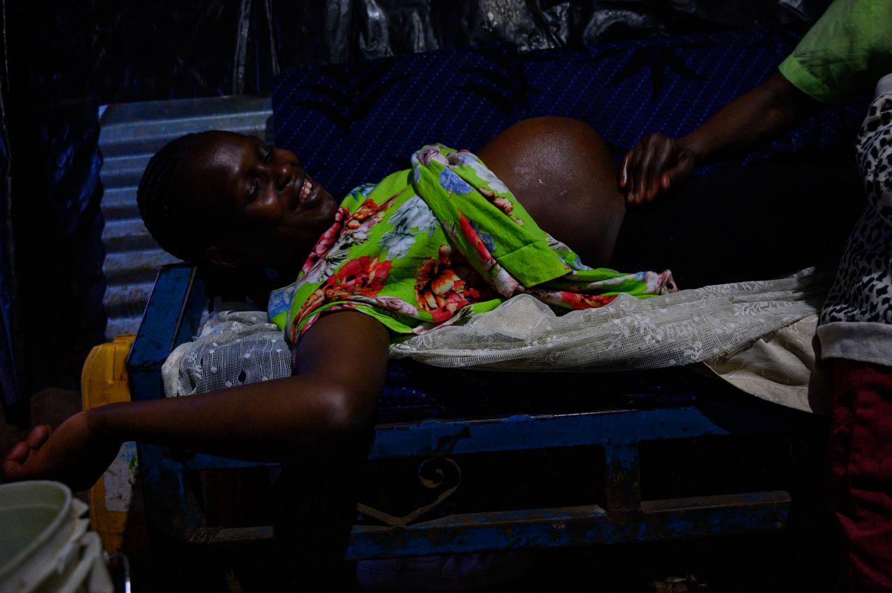 Image from Gordwin Odhiambo | Reinventing and Adapting Through Coronavirus - A mother in labour is massaged by a midwife at night in...
