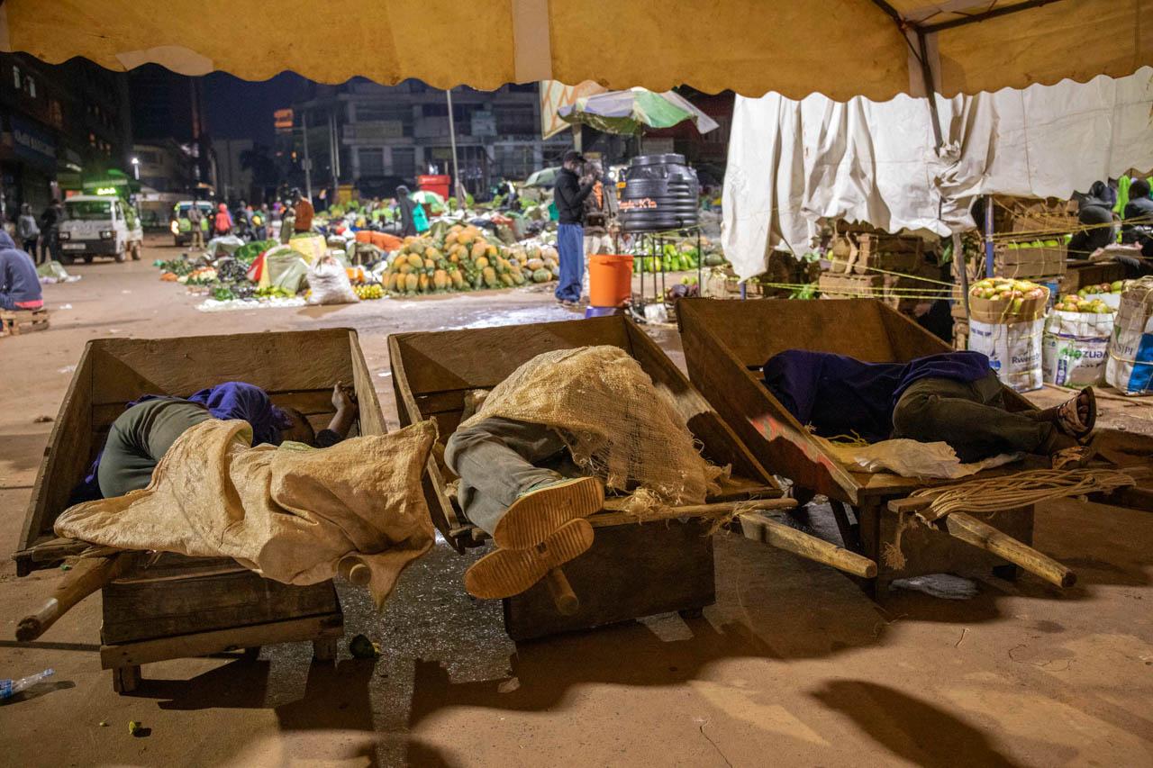 Wheelbarrow pushers and cargo men at Nakasero market deep asleep