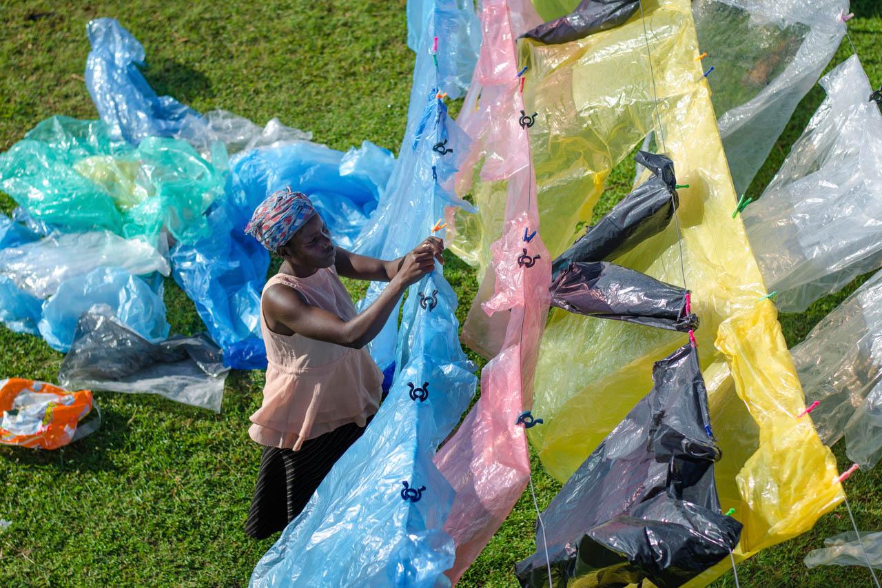 A woman washes waste plastics which will be recycled into waterproof bags and accessories.