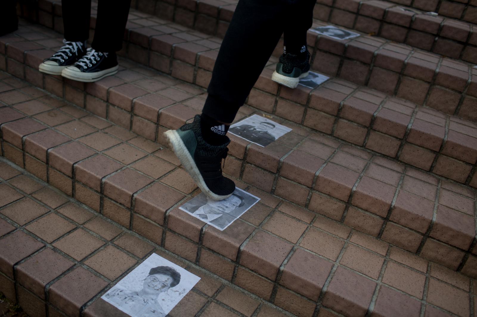 Protesters step on pictures of ... Hong Kong on January 12, 2020.