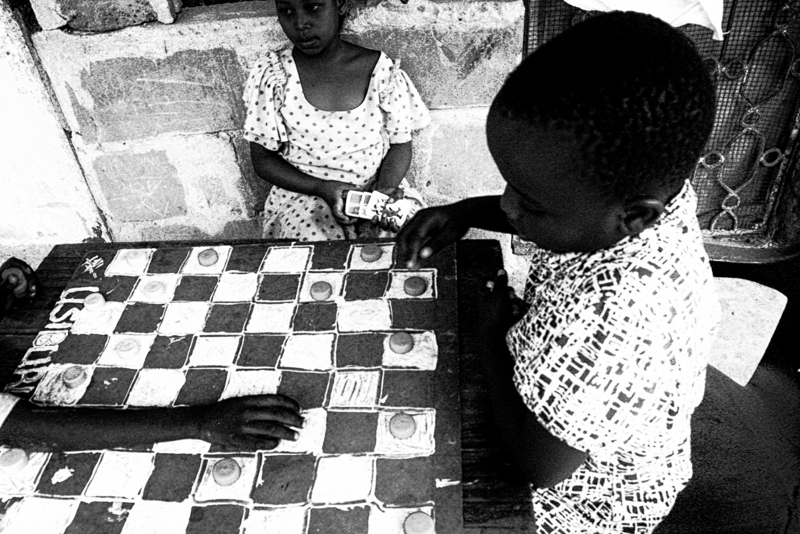 Young girls play a handmade che...the same time just to have fun.