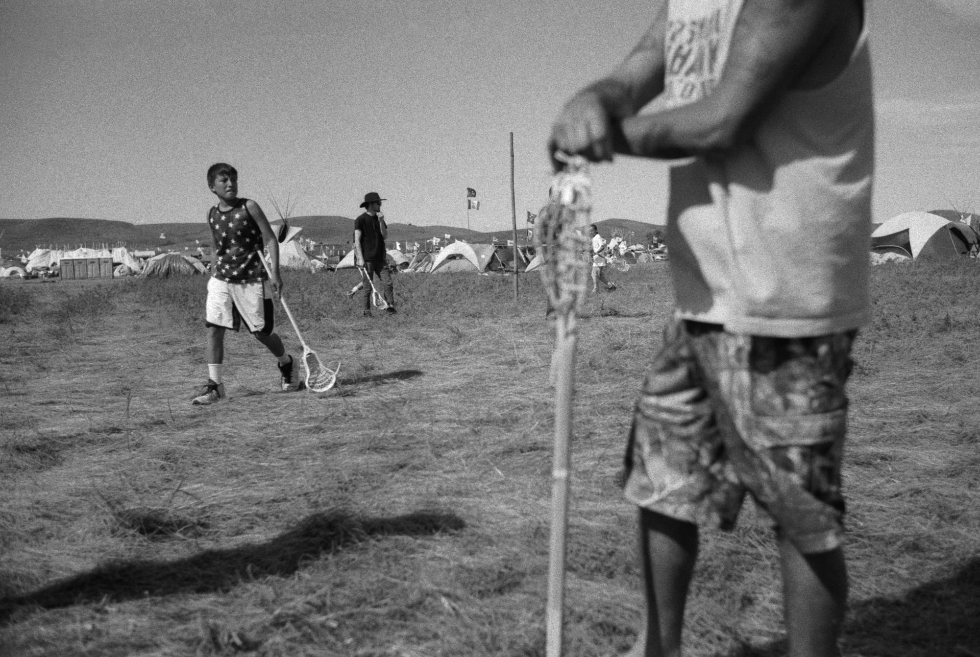 Standing Rock - Playing lacrosse on a sunny day in the Oceti Sakowin...