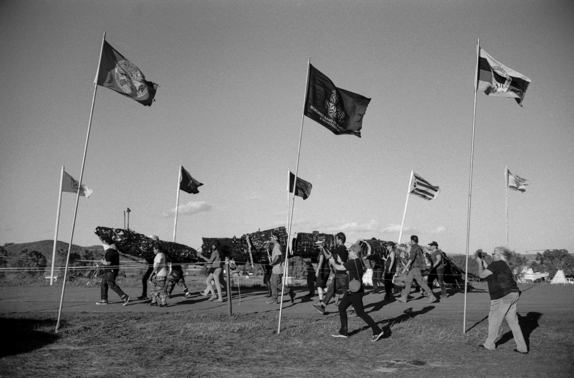 Standing Rock - Through an alley of flags brought by hundreds of...