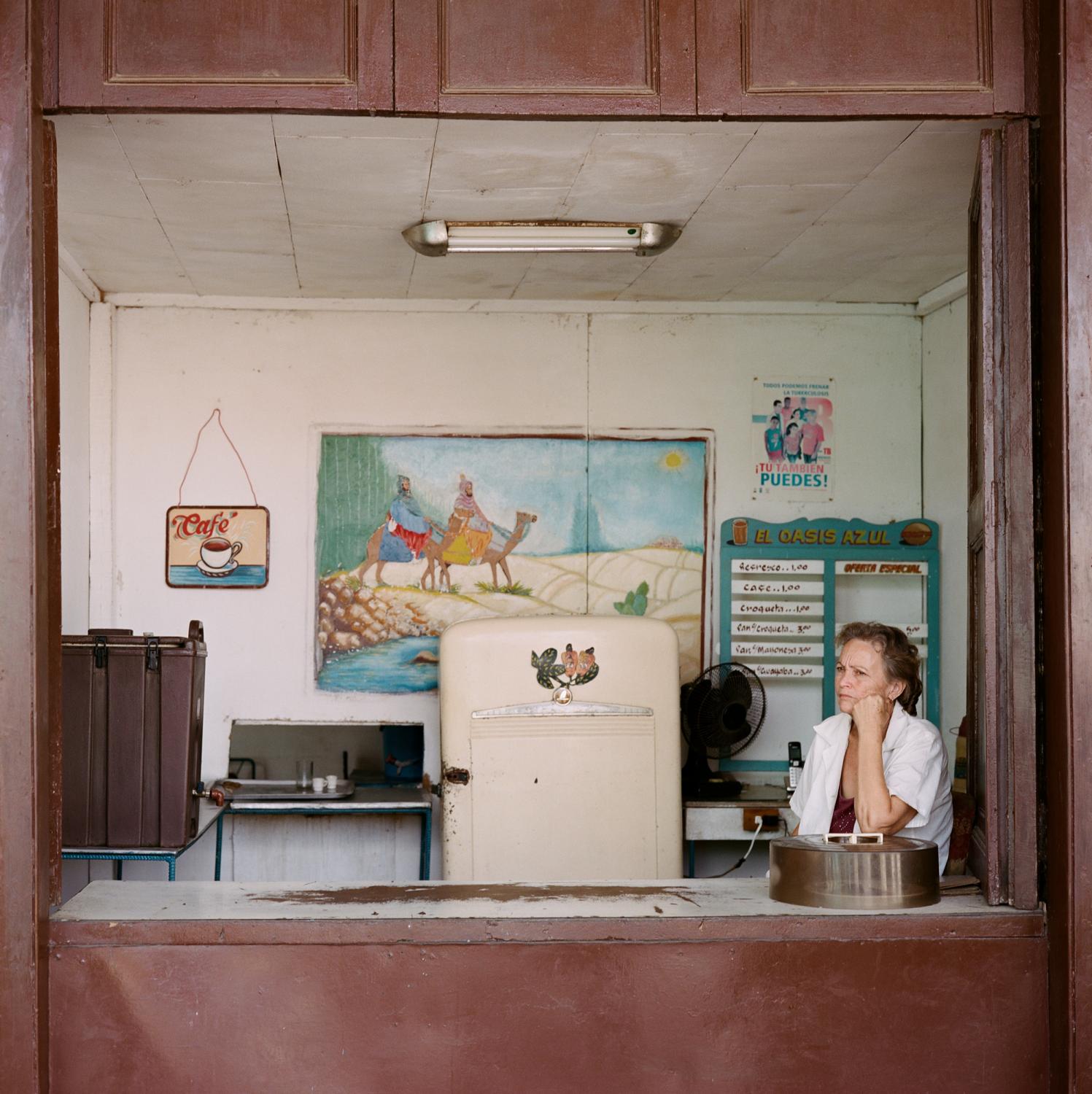 Tobaccoland - SAN LUÍS.  Marielena waits for customers in a cafe...
