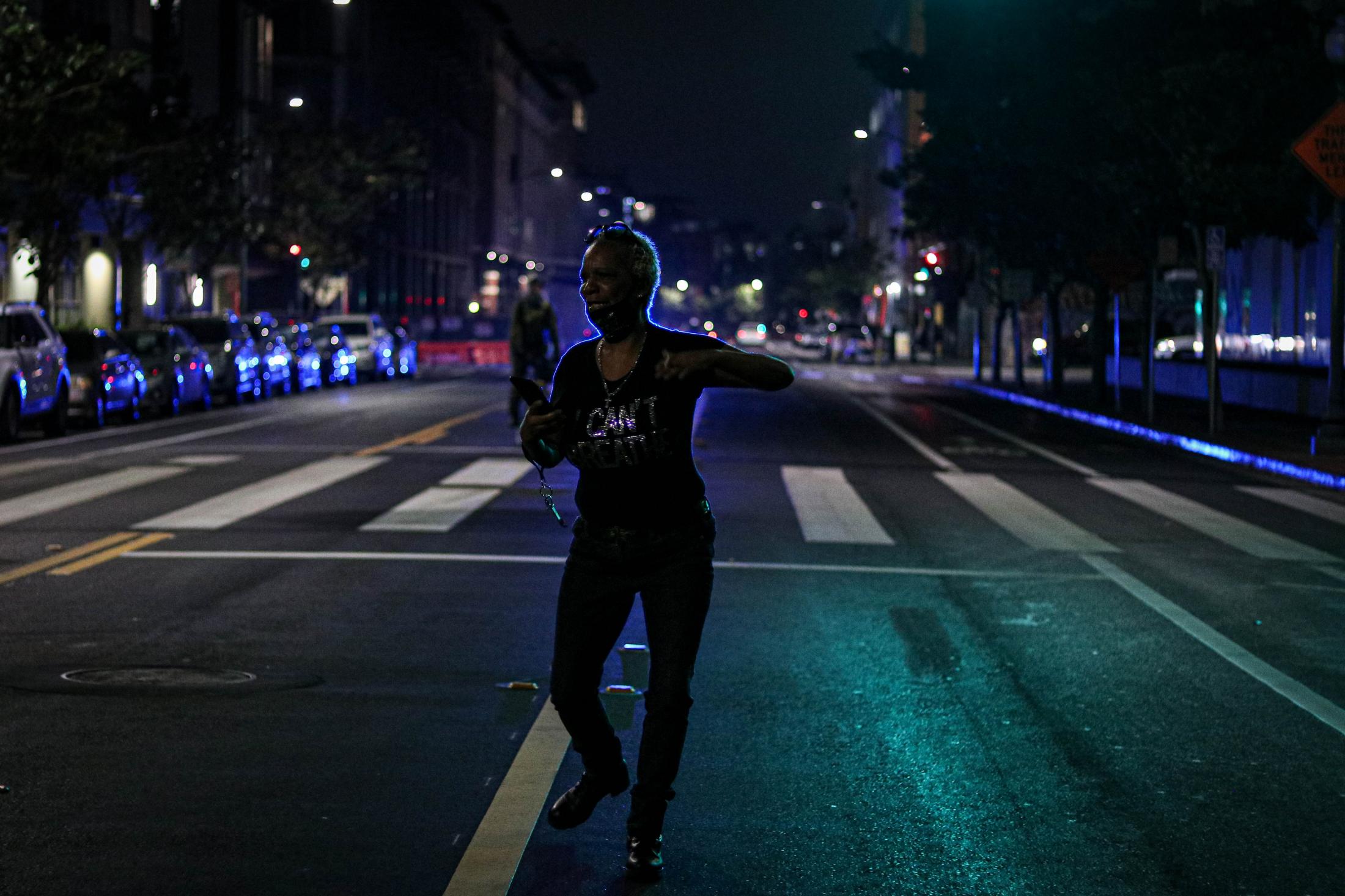 Protests - A protester dances in the middle of the street to...