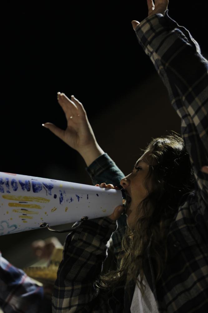 Helias Catholic High School senior Emily Knox screams into a megaphone as the Cavaliers flooded the field before the game on Oct. 16, 2020, in Jefferson City. &quot;Howdy, howdy, let&#39;s get rowdy&quot; was written on the megaphone as part of the &#39;Country Hick&#39; game theme.