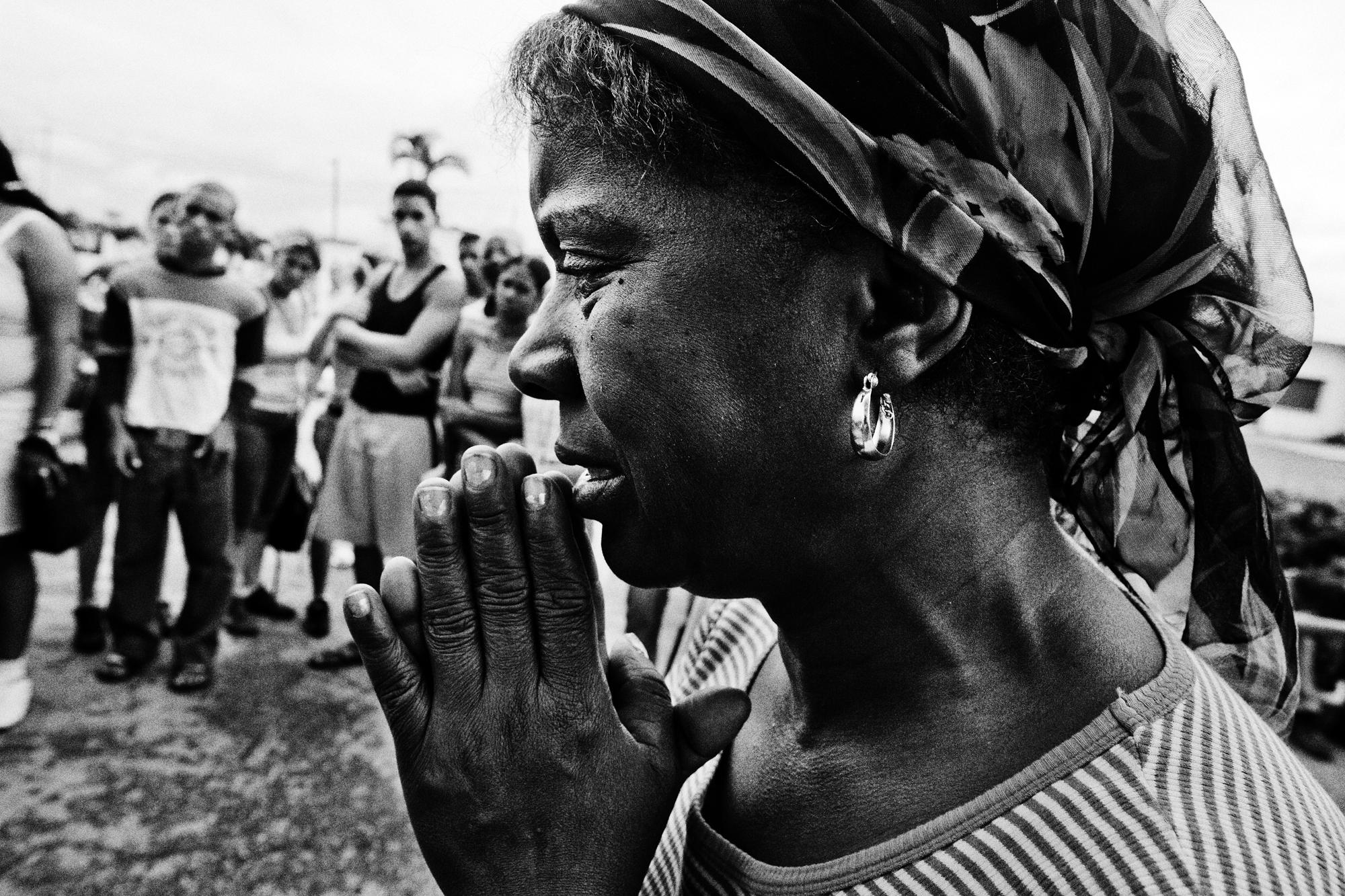 San Lázaro  - Cuba, El Rincon (Santiago de la Vega). A woman is praying...