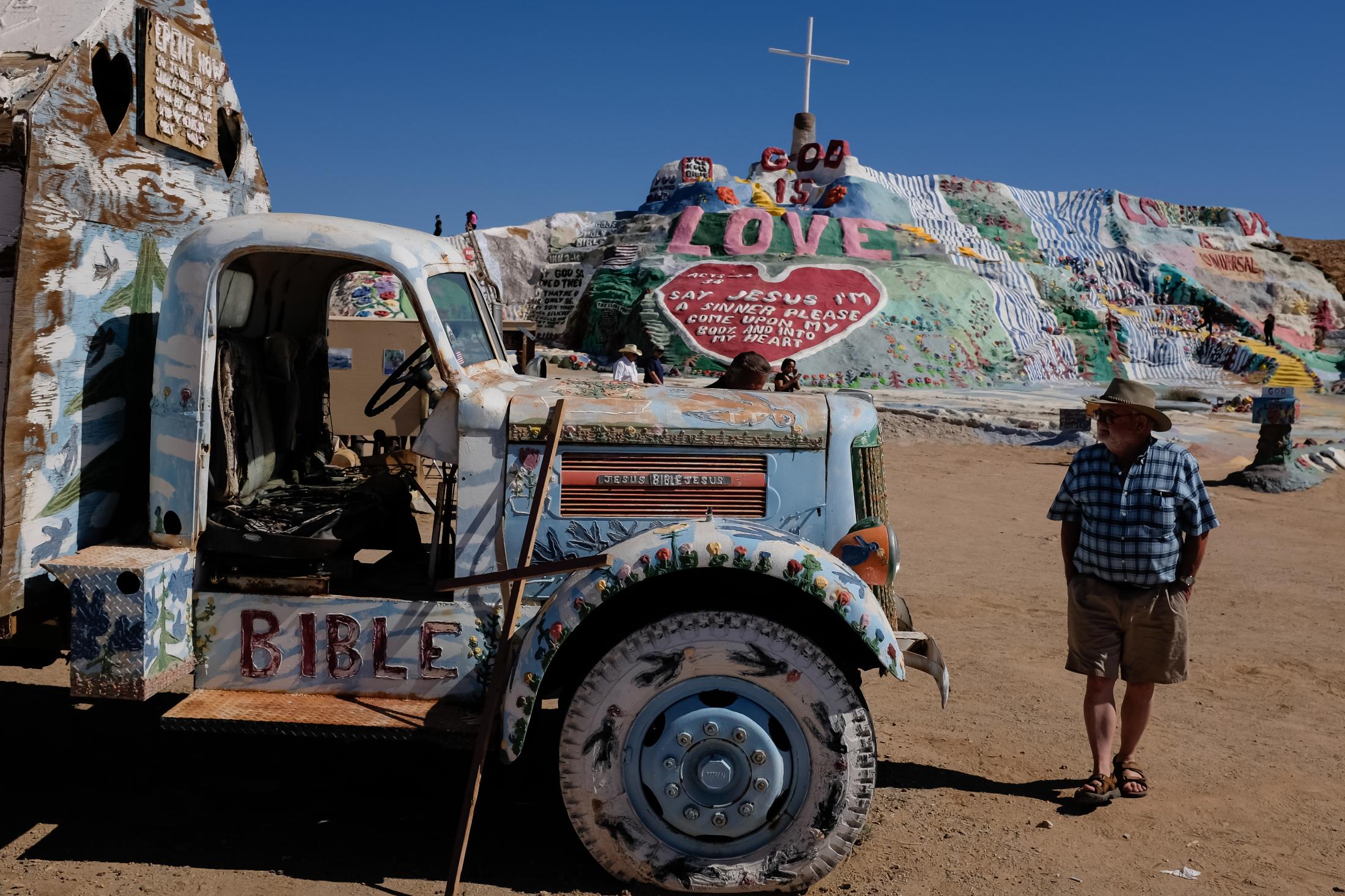 Last Free Place - A man walks the grounds of Salvation Mountain that brings...