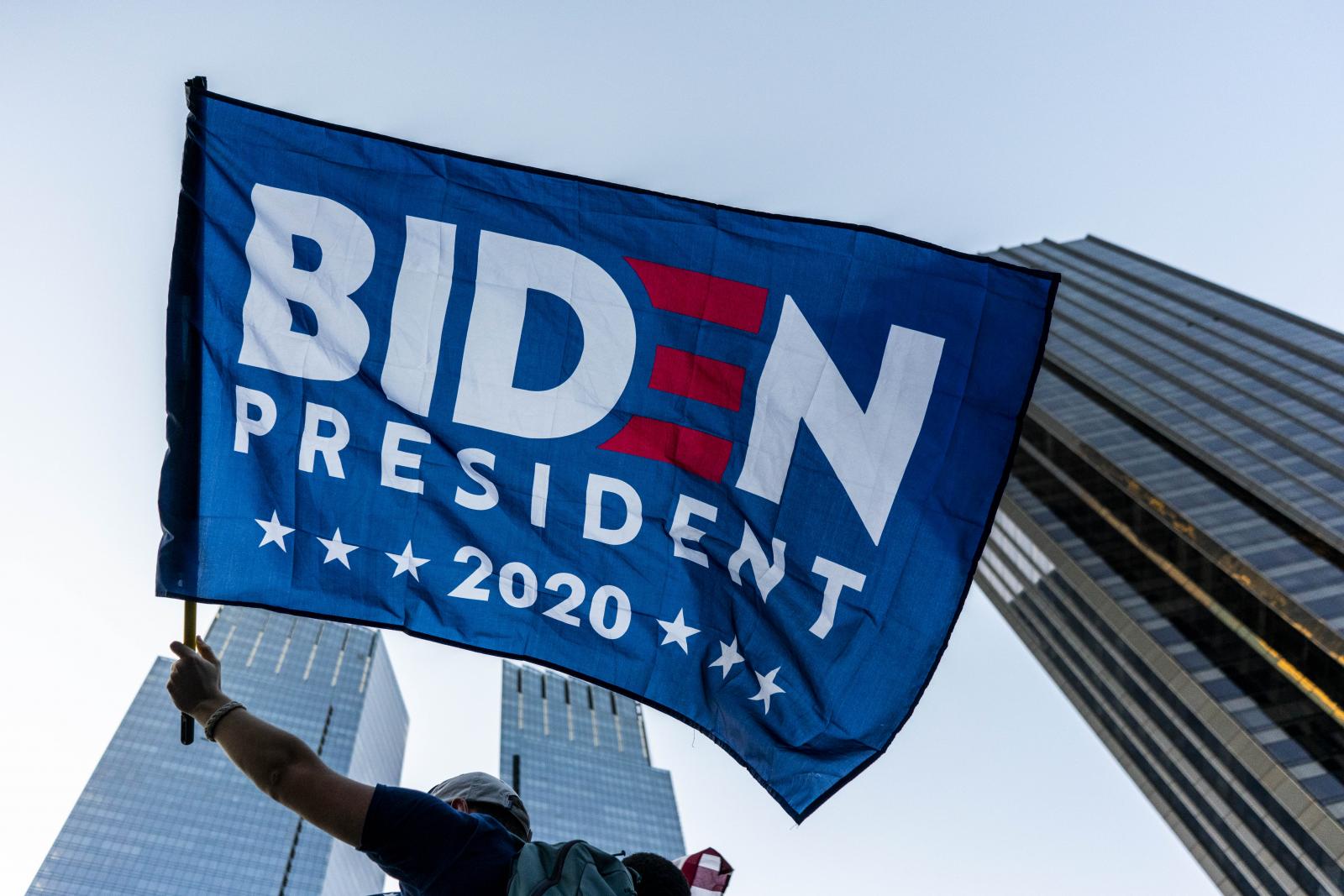 A person waves a Biden Presiden... Election against Donald Trump.