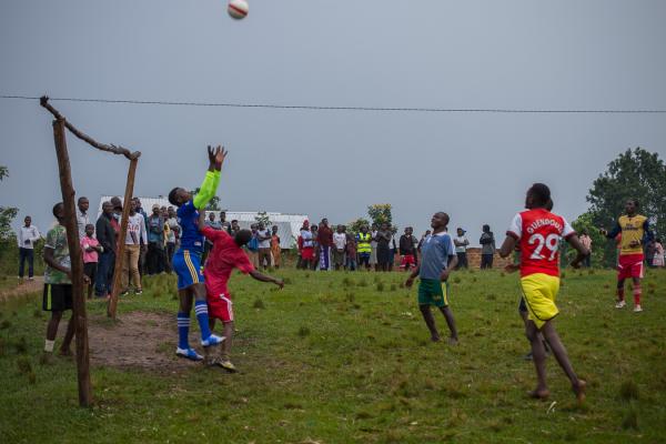 Image from ROAD TO UGANDA DECIDES - A goalkeeper reaches for the ball as an opposing striker...