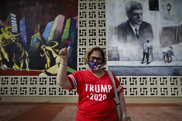 Image from 2020 - Presidential Elections @ Miami, FL - A U.S. President Donald Trump supporter poses for a photo...